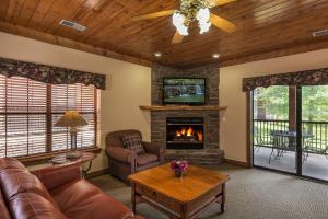 a living room with a couch and a fireplace at Westgate Branson Woods Resort in Branson