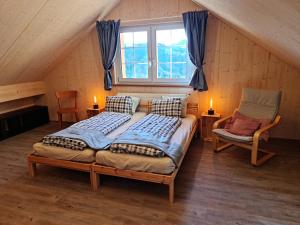 a bedroom with a bed and a chair in a attic at Grosses Ferienhaus für traumhafte Familienferien im Appenzellerland in Speicher +25 photos