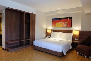 Voodi või voodid majutusasutuse Next Hotel Yogyakarta toas