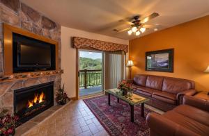 a living room with a couch and a fireplace at Westgate Branson Woods Resort in Branson