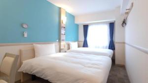 Voodi või voodid majutusasutuse Toyoko Inn Yokohama Shiei-chikatetsu Center Minami-eki toas