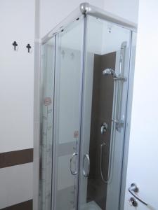 a shower with a glass door in a bathroom at La Casa Del Gelso Bianco in Otranto