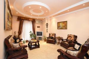 a large living room with chairs and a tv at Guest house YEREVAN in Yerevan