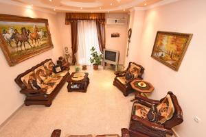 a large living room with couches and a tv at Guest house YEREVAN in Yerevan