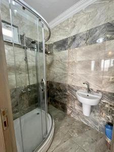 a bathroom with a shower and a sink at kayan apart in Trabzon