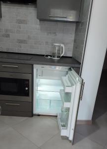 an empty refrigerator with its door open in a kitchen at 1 кк люкс лофт студия in Mykolaiv