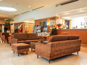 a lobby with chairs and a counter in a store at HOTEL LiVEMAX BUDGET Kagoshima in Kagoshima