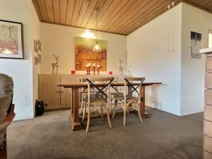 a dining room with a wooden table and chairs at Snow Gums Apartment 4, alpine-getaways in Dinner Plain