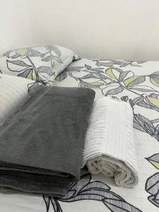 a bed with a blanket and two pillows on it at APTO aconchegante in Manaus