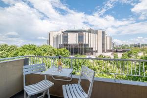 a balcony with a table and chairs and a city skyline at Sunrise City View Apt / NDK in Sofia