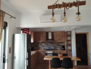 a kitchen with wooden cabinets and a wooden table at Olivelia in Ixia