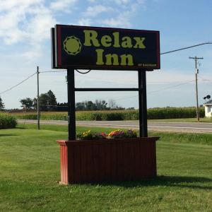 a sign for a relax inn in a field at Relax Inn - Saginaw in Saginaw