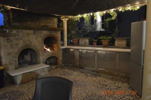 a patio with a stone fireplace with a stove at Villa Dacia in Guiglia