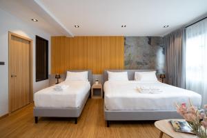 A bed or beds in a room at โรงแรมอินฟินิทเกษตร