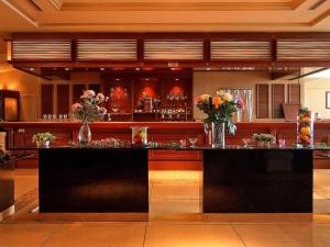 a bar with vases of flowers on top of it at Rizzan Sea Park Hotel Tancha Bay in Onna