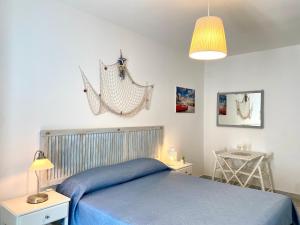 En eller flere senger på et rom på Dimore Aria di Mare - Puglia Mia Apartments