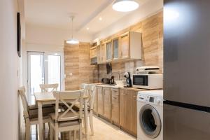 a kitchen with a table and chairs and a microwave at Kamelia Apartment in Rhodes Town