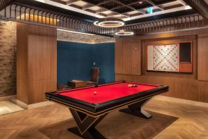 a billiard room with a red pool table at Taj Exotica Resort & Spa, The Palm, Dubai in Dubai