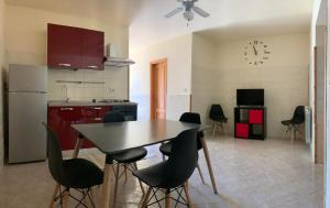 a kitchen with a table and chairs in a room at Casa dell'Etna in Santa Venerina