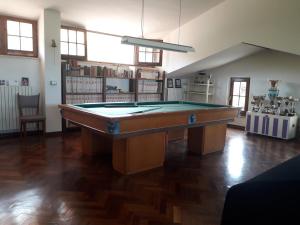 a room with a pool table in the middle of it at Villino Sabina in Civitella del Tronto