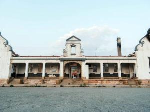 an old building with a clock tower on top of it at Cosy - Best Rest Potch in Potchefstroom