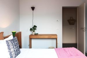 a bedroom with a bed and a table at Picobello Lago in Mandello del Lario