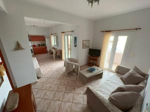 a living room with a couch and a table at Coastal Charm-Getaway to Artichoke's Seaside Oasis in Xerokampos