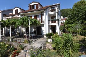 a house with a garden in front of it at Apartments Budva Center in Budva