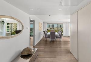 a dining room with a table and a mirror at Water Front Luxury Family Apartment in Herzliya