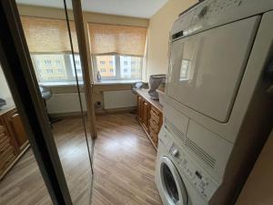 uma lavandaria com máquina de lavar e secar roupa em The Baltic coast apartment em Ventspils