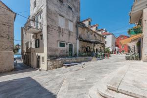 an empty street in an old town with buildings at Heritage Palace LIŠTUN in Makarska