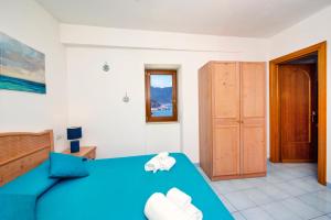 a bedroom with a blue bed and a door at La Sciuscella in Conca dei Marini +48 photos