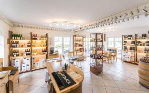 a store with a lot of shelves with wine bottles at Cafe Klering in Briedern