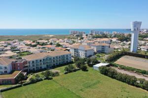 an aerial view of a city with a water tower at Une grande maison pour 10 proche de la mer in Saint-Gilles-Croix-de-Vie