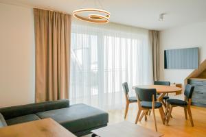 a living room with a table and a couch at Nadland Apartments B61 in Vienna