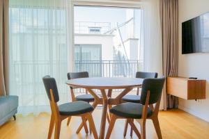 a table and chairs in a room with a window at Nadland Apartments B61 in Vienna