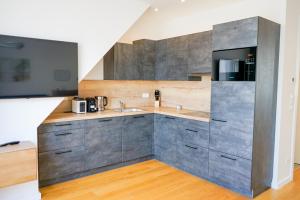 a kitchen with a sink and a microwave at Nadland Apartments B61 in Vienna