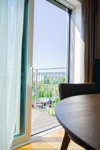 a table and chair in front of a large window at Nadland Apartments B61 in Vienna