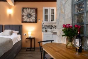 a bedroom with a bed and a table with roses at Casa Albina in Rovinj