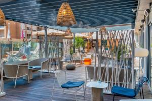 d'une terrasse avec des chaises et des tables. dans l'établissement Mercure Toulouse Centre Saint-Georges, à Toulouse