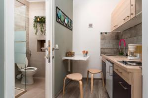 a small kitchen with two stools and a toilet at Casa Albina in Rovinj +67 photos