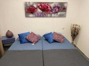 a bedroom with a bed with pillows on it at Case Di A Cappana-Villa CARLA in Bonifacio