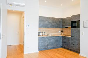 a kitchen with gray cabinets and a sink at Nadland Apartments B61 in Vienna