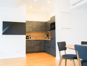 a kitchen with a table and chairs in a room at Nadland Apartments B61 in Vienna