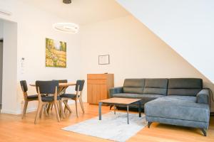 a living room with a couch and a table at Nadland Apartments B61 in Vienna