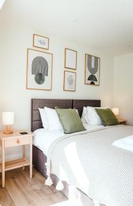a bedroom with two beds and a side table at Border View Cottage in Duddo