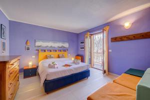 a blue bedroom with a bed and a window at Rebecca's House few steps from skiing - Happy Rentals in Bardonecchia