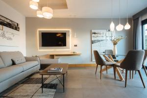 a living room with a couch and a table at Guadalupe 15 by Magno Apartments in Seville