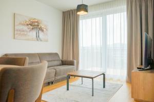 a living room with a couch and a table at Nadland Apartments B61 in Vienna