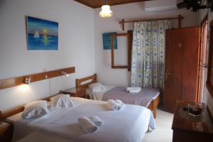 Postel nebo postele na pokoji v ubytování Hotel Eleftheria